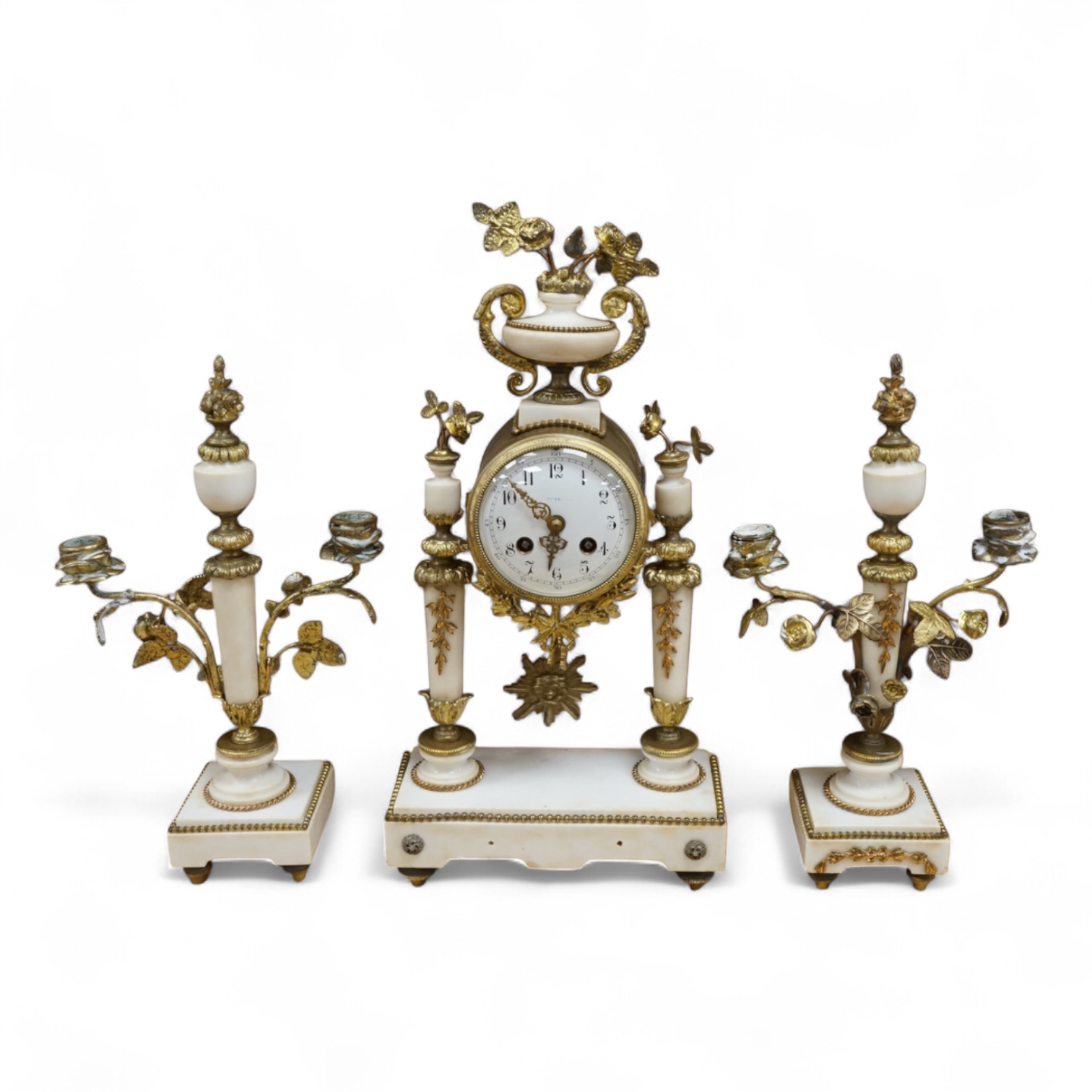A 19th French white marble and gilt metal clock garniture, c.1900, striking on a bell, with pendulum, 45cm high